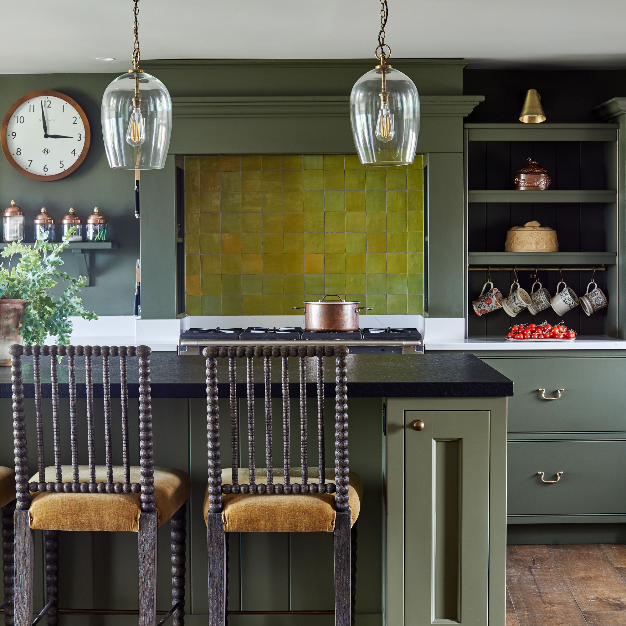 Green kitchen with green tiles and glass pendant lights