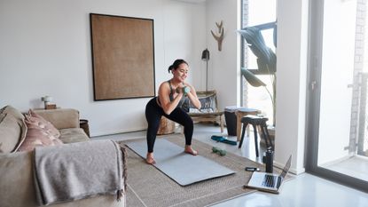 Woman holding a dumbbell goblet squat