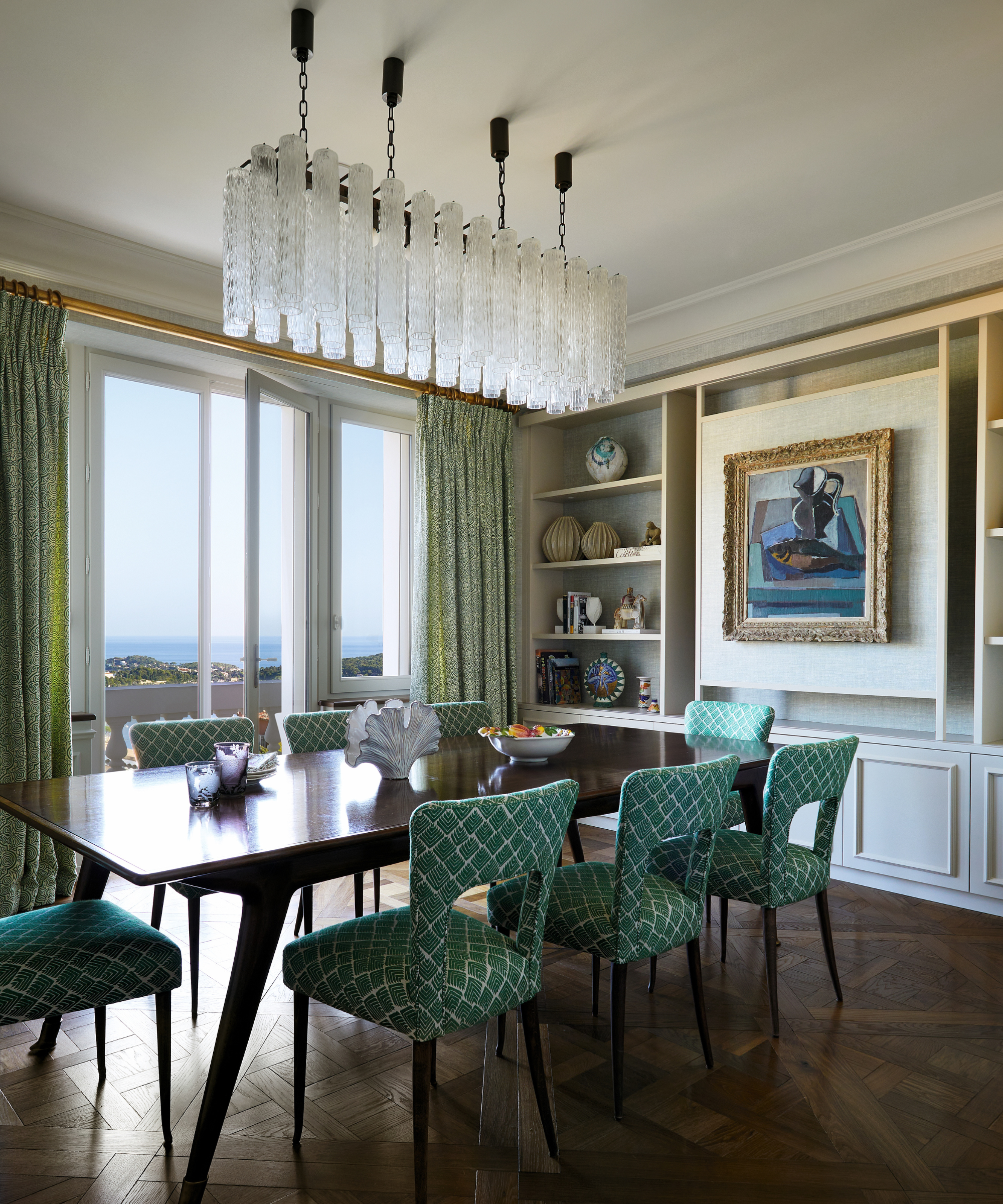 dining area with green chairs and chandelier
