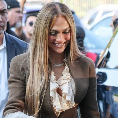Jennifer Lopez attended a 'Kiss of the Spider Woman' event in a boho-chic brown suit and ruffled sleeves