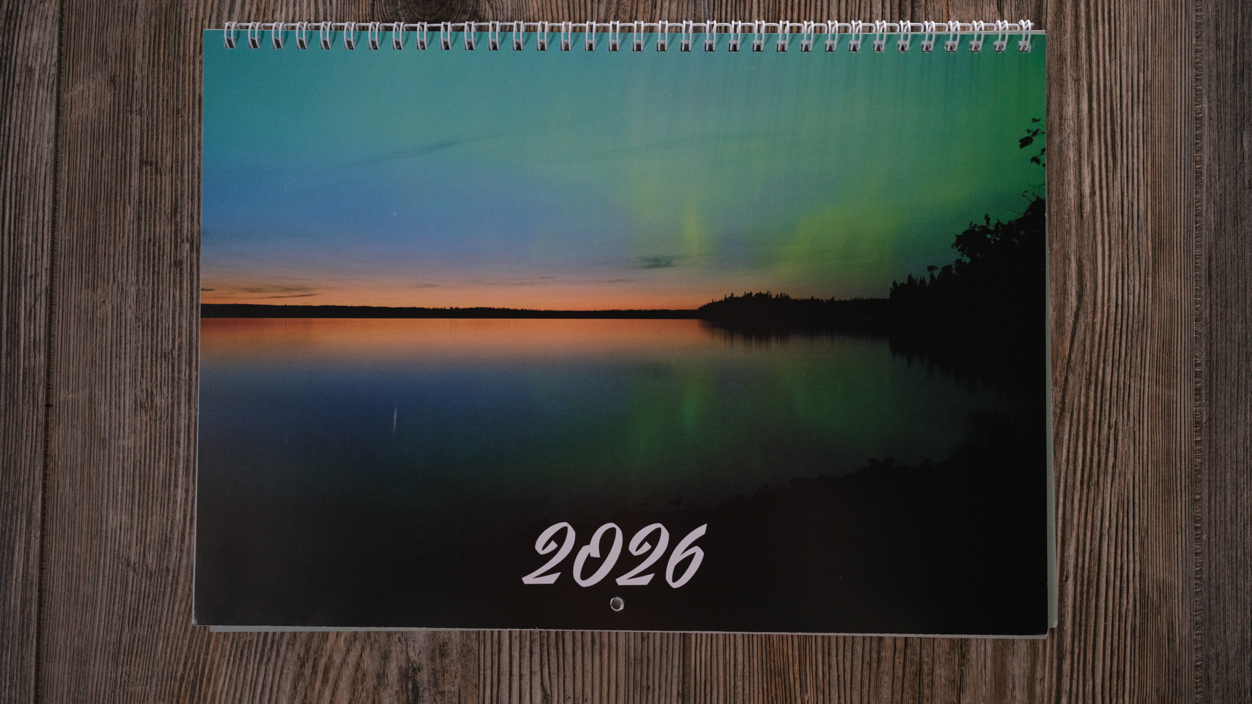 A photo calendar from Vistaprint on a wood background
