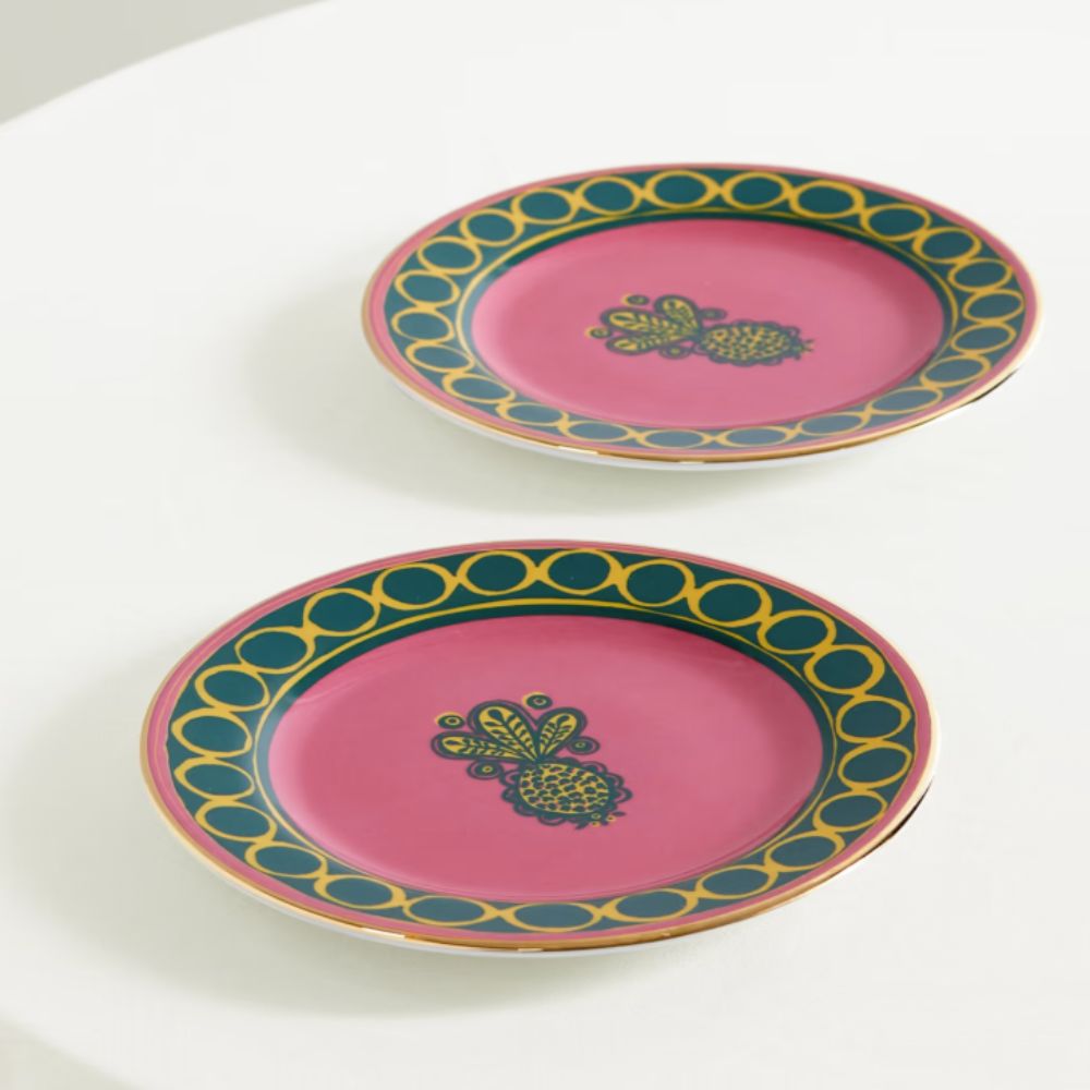 pink and green patterned dessert plates with gold edging