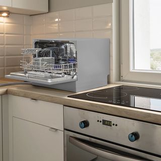 a small counter top dishwasher in a small kitchen