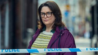 Ruth Jones stands behind police tape