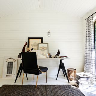 study room with white wall and black table with white chair