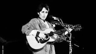 US Folk singer Joan Baez gives a concert on the parvis of Notre Dame de Paris cathedral on Christmas Eve in front of 25000 Parisians on December 24, 1980. AFP PHOTO PIERRE GUILLAUD