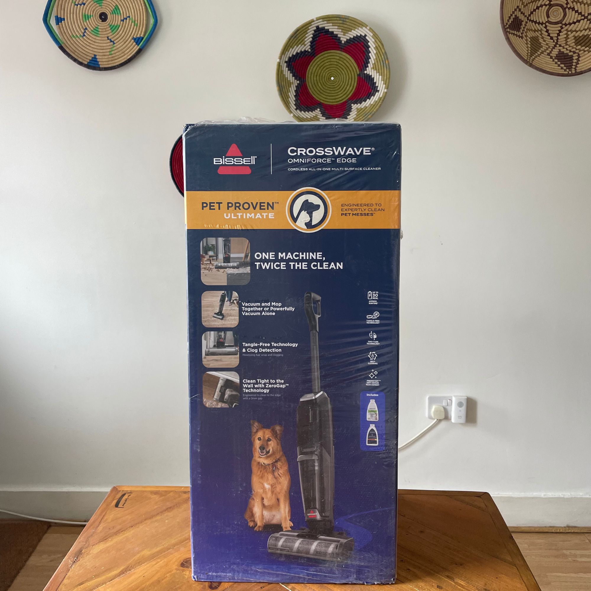 Bissell Crosswave Omniforce Edge box on a wooden table in front of a white wall