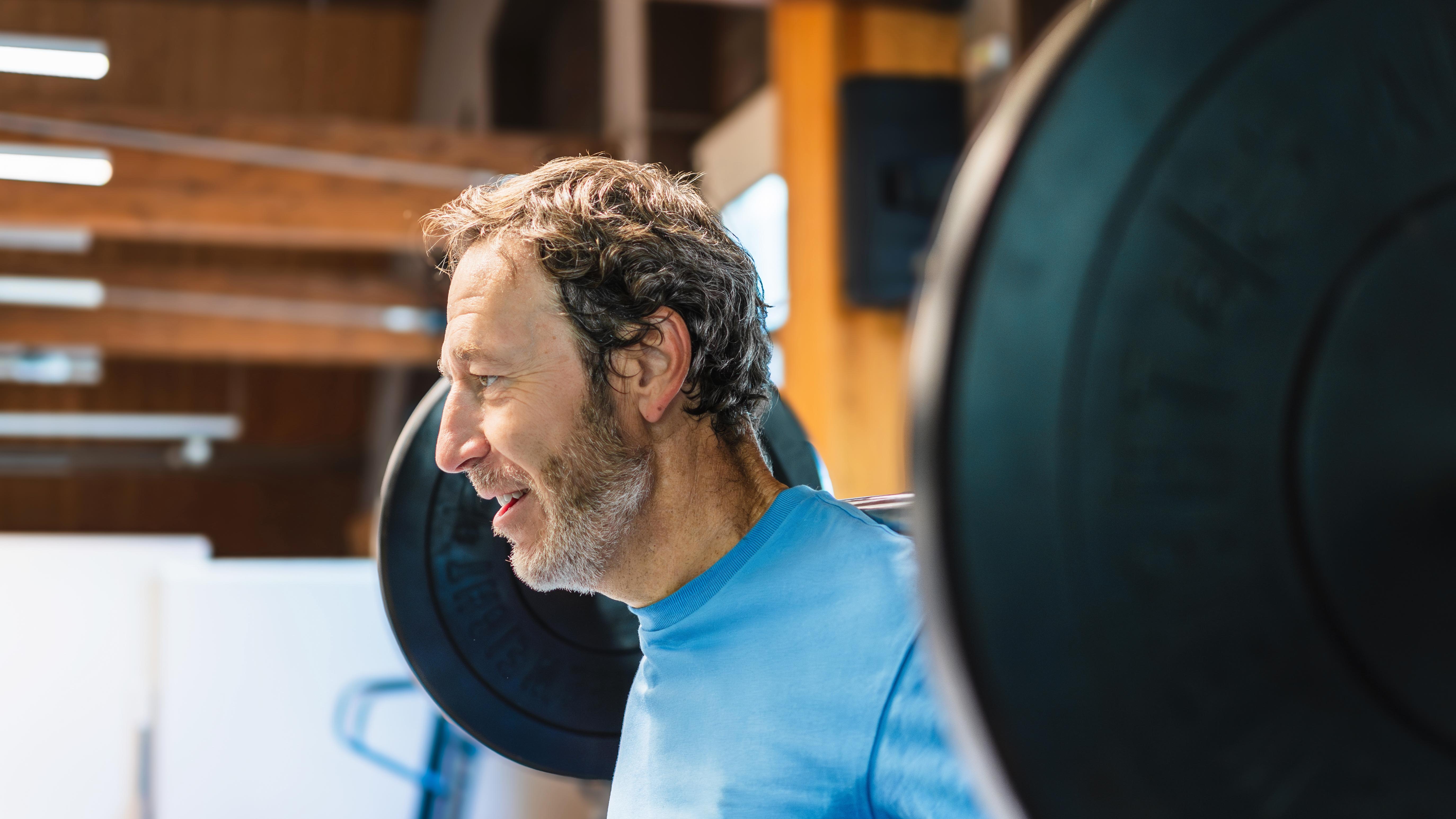 a middle age man doing squats