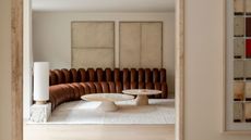 a minimalist neutral living room with a leather de sede sofa