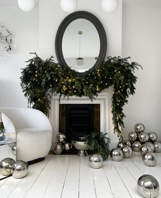 a fireplace surrounding by oversized christmas ornaments