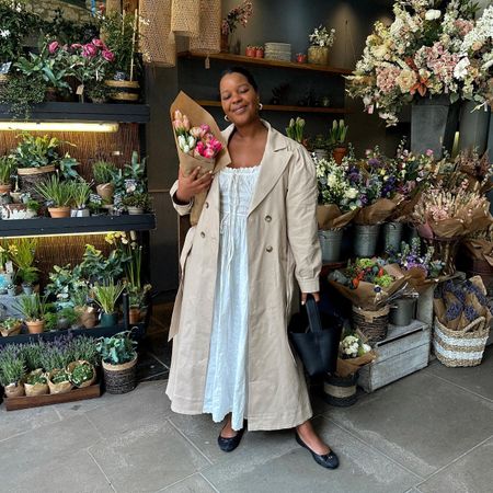 Summer rainy day outfits: @styleidealist wears a trench coat, midi dress and ballet flats