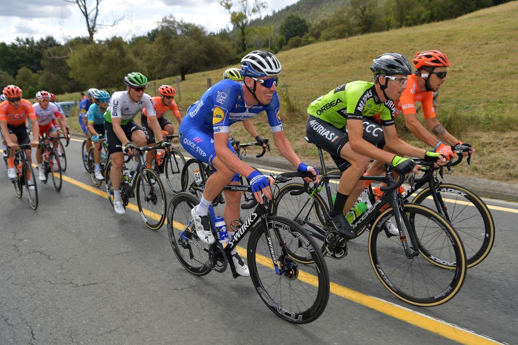 Two men from the stage 12 break, Tim Declercq and Fernando Barcel&oacute;, ride in the peloton