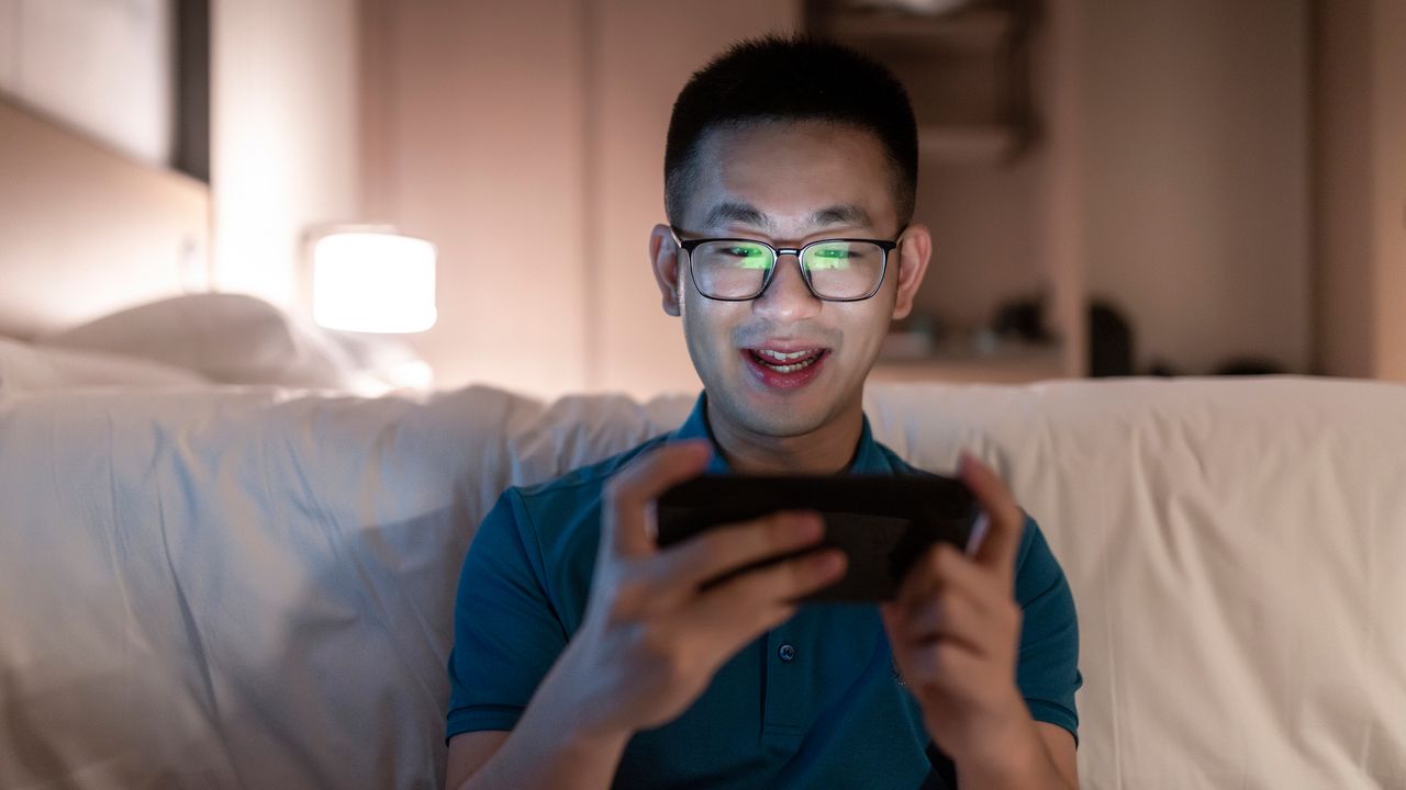 Man playing smartphone games