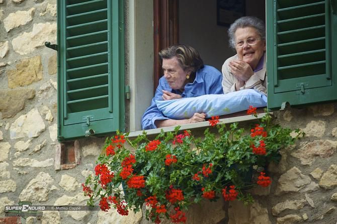 This is Italy. The local people were watching the riders with curiosity and wonder from the comfort of home
