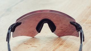 A red pair of sunglasses on a wooden table