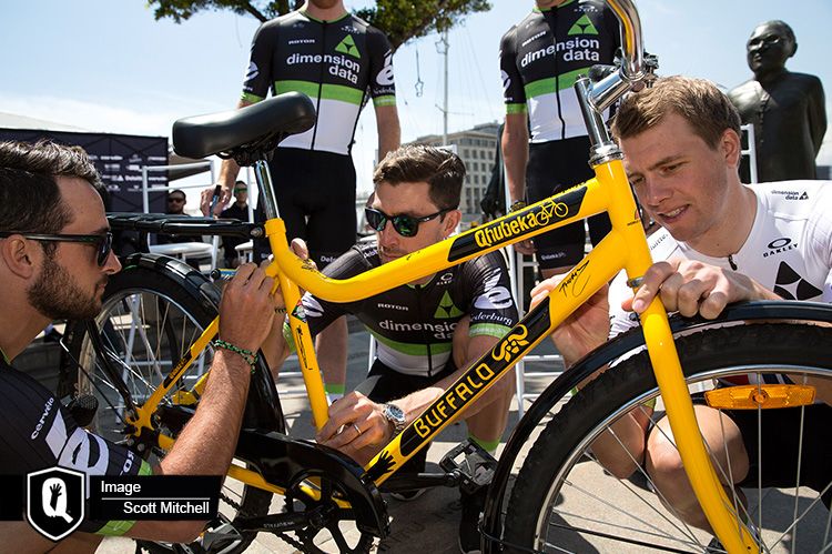 Riders autograph a Qhubeka bike