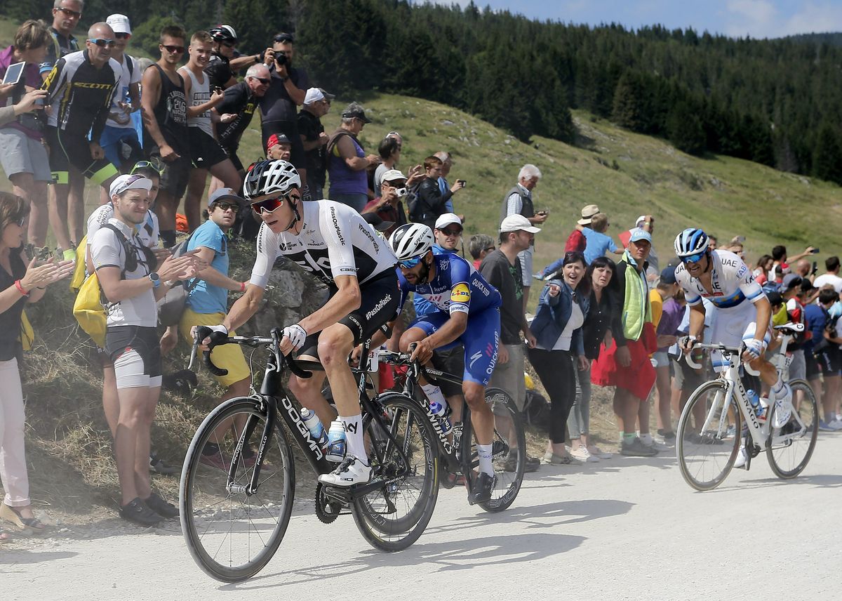 Chris Froome (Team Sky) chases back after a puncture on stage 10
