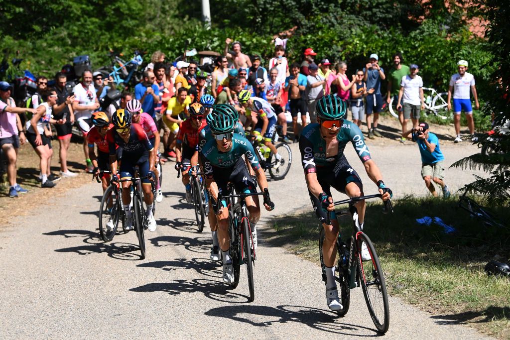 TURIN ITALY MAY 21 LR Jai Hindley of Australia and Wilco Kelderman of Netherlands and Team Bora Hansgrohe leads the peloton while fans cheer during the 105th Giro dItalia 2022 Stage 14 a 147km stage from Santena to Torino Giro WorldTour on May 21 2022 in Turin Italy Photo by Tim de WaeleGetty Images