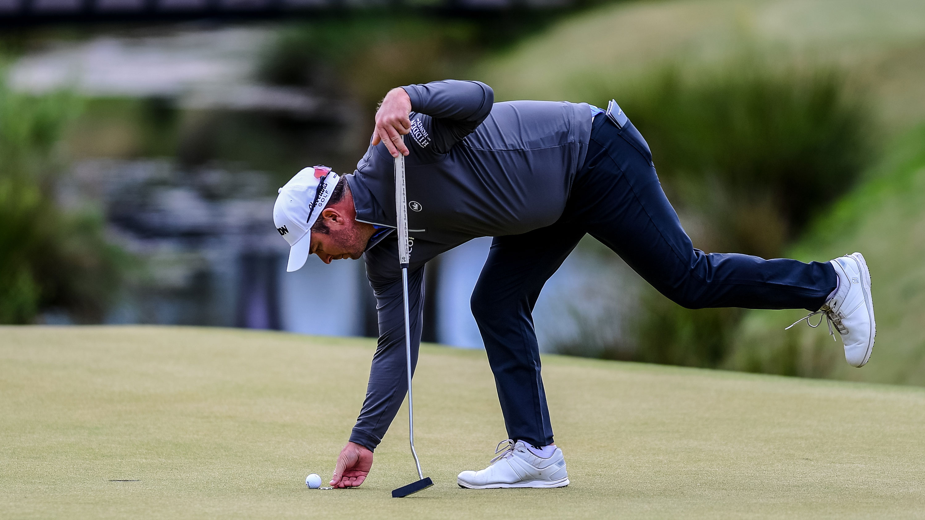 Ryan Fox marking his golf ball on the green