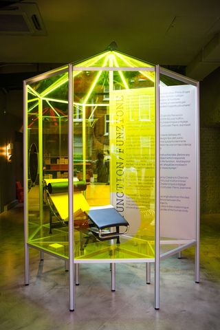 Octagonal exhibit enclosed in yellow Plexiglas