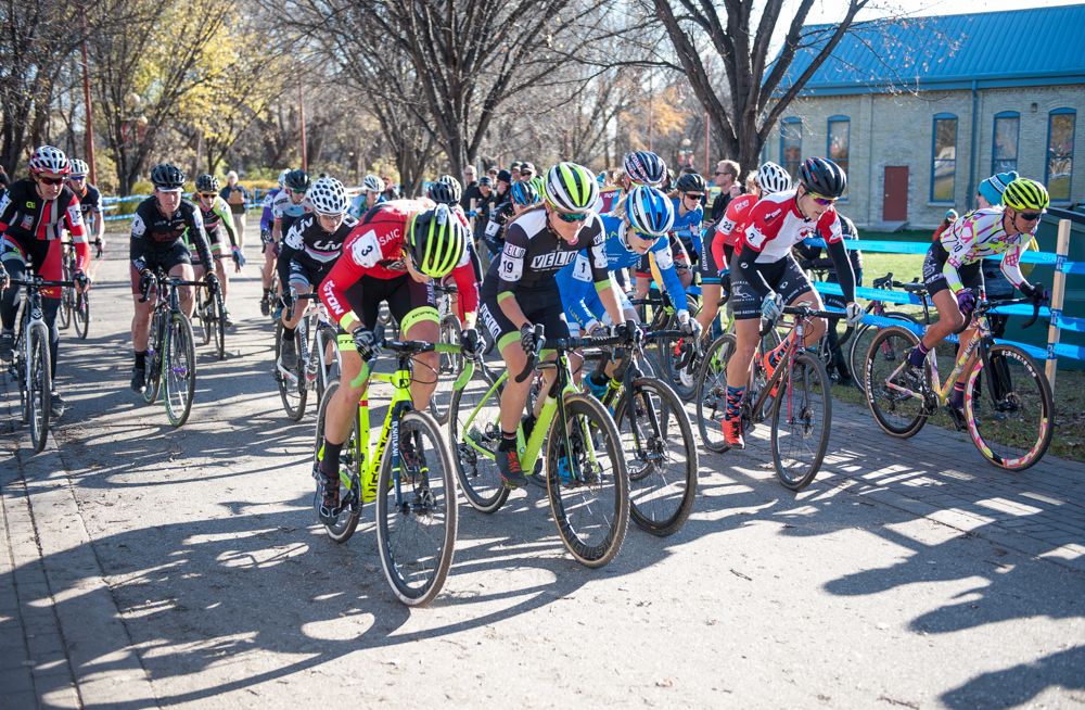 Elite women take off down the pavement before heading onto grass