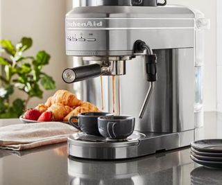 KitchenAid espresso machine in grey on a countertop pulling espresso shots into two cups