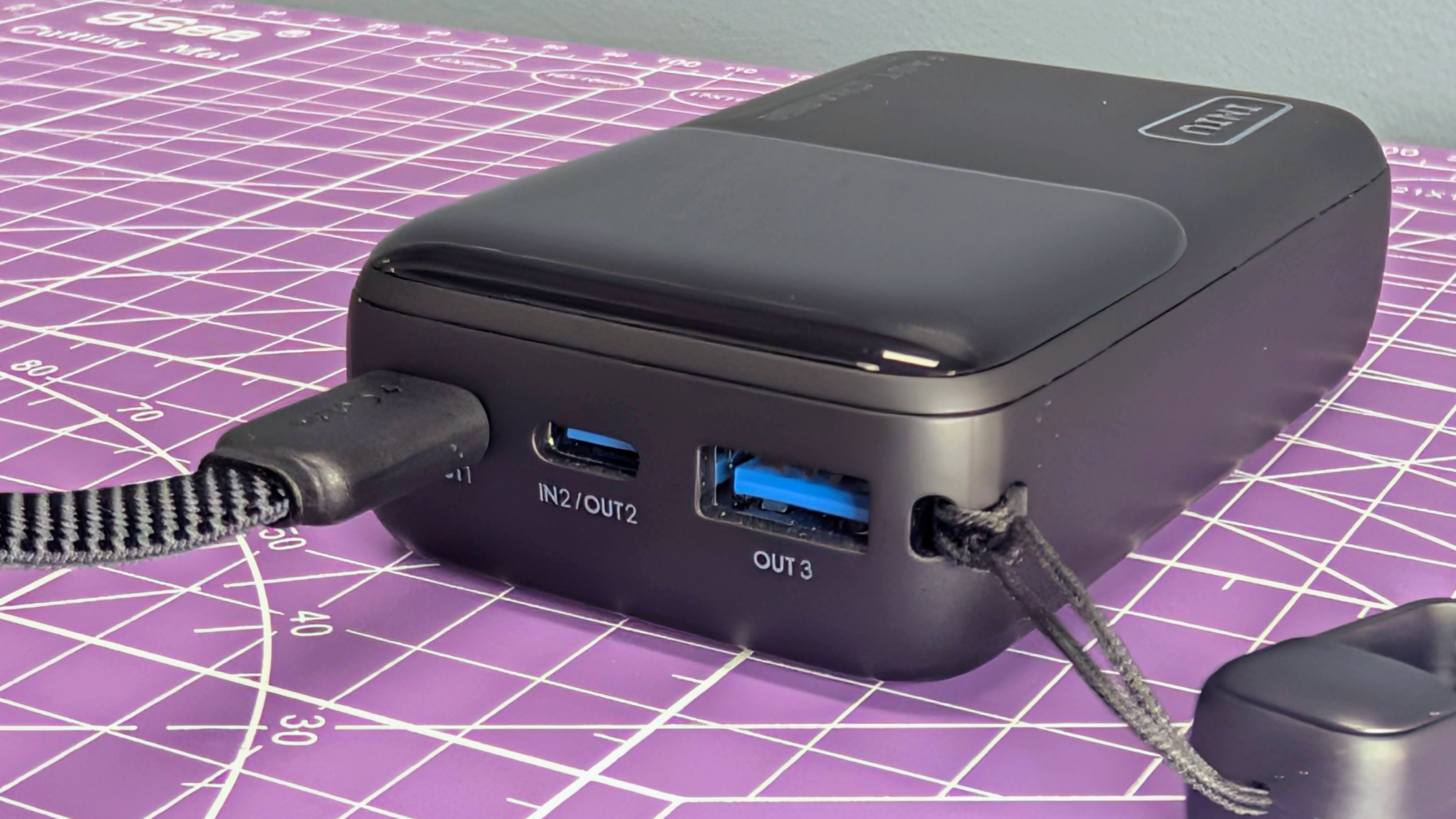 Iniu P50-E1 45W power bank front angle with cable plugged in
