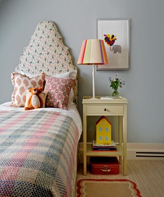 child's room with a mix of eclectic prints and a statement shaped headboard
