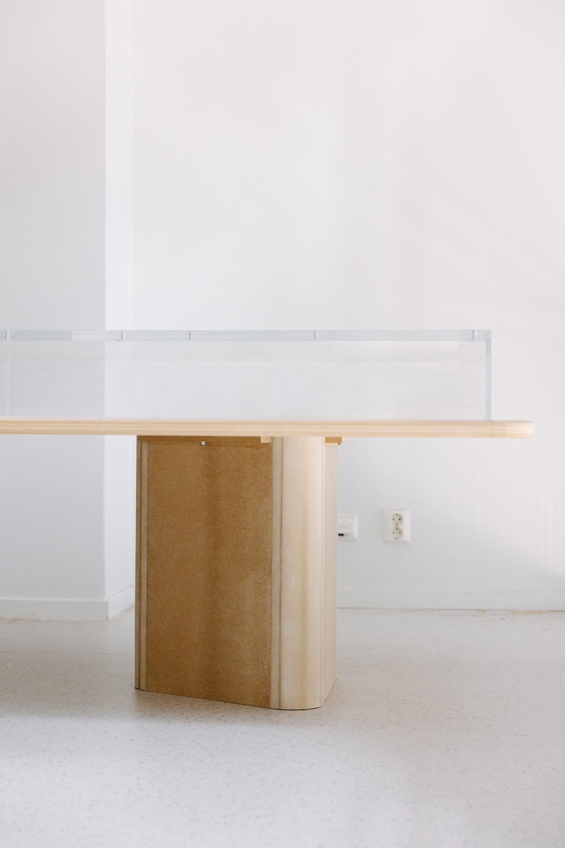 An empty glass vitrine next to white wall