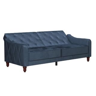 A blue velvet sofa bed cut out on a white background.