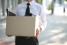 Man in suit holding box