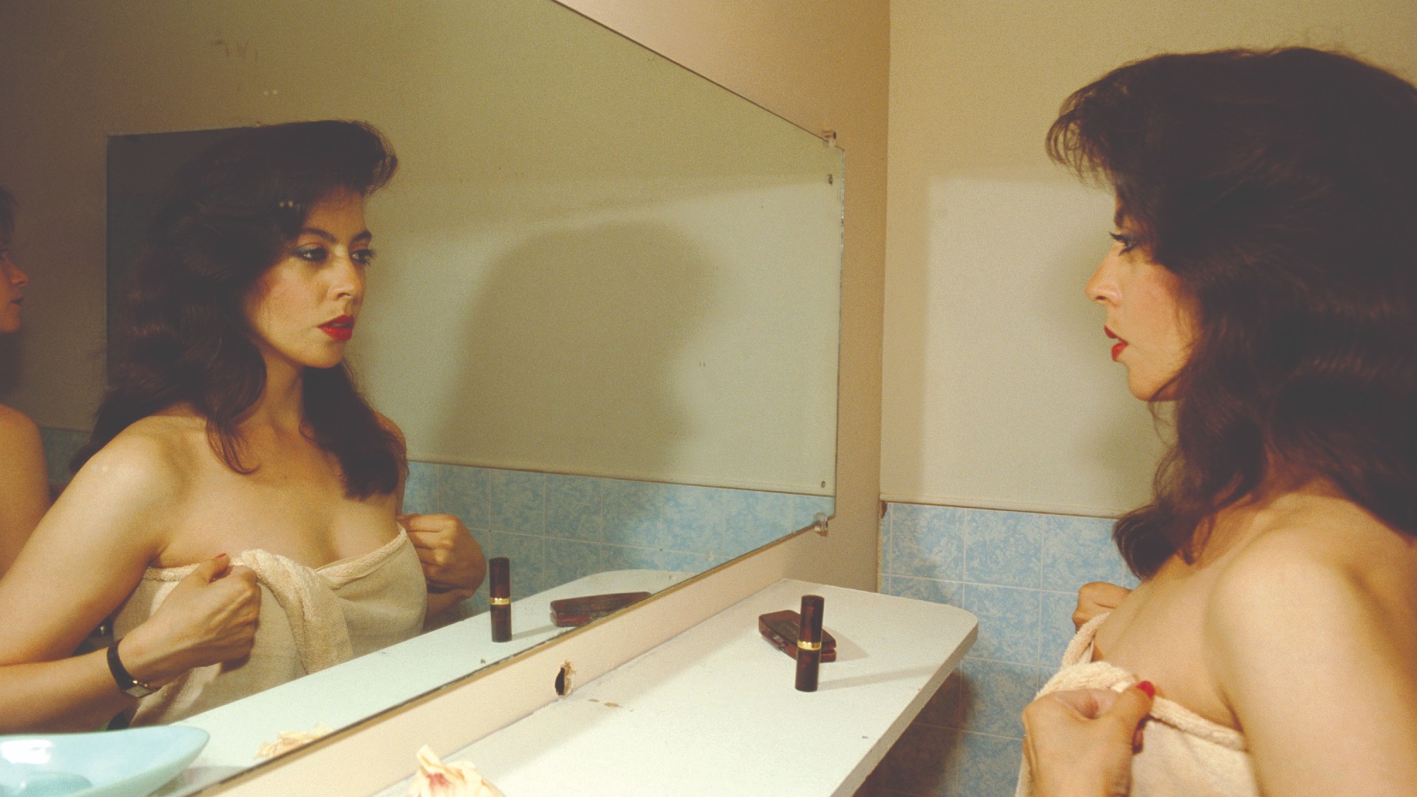 women staring into a mirror at her reflection