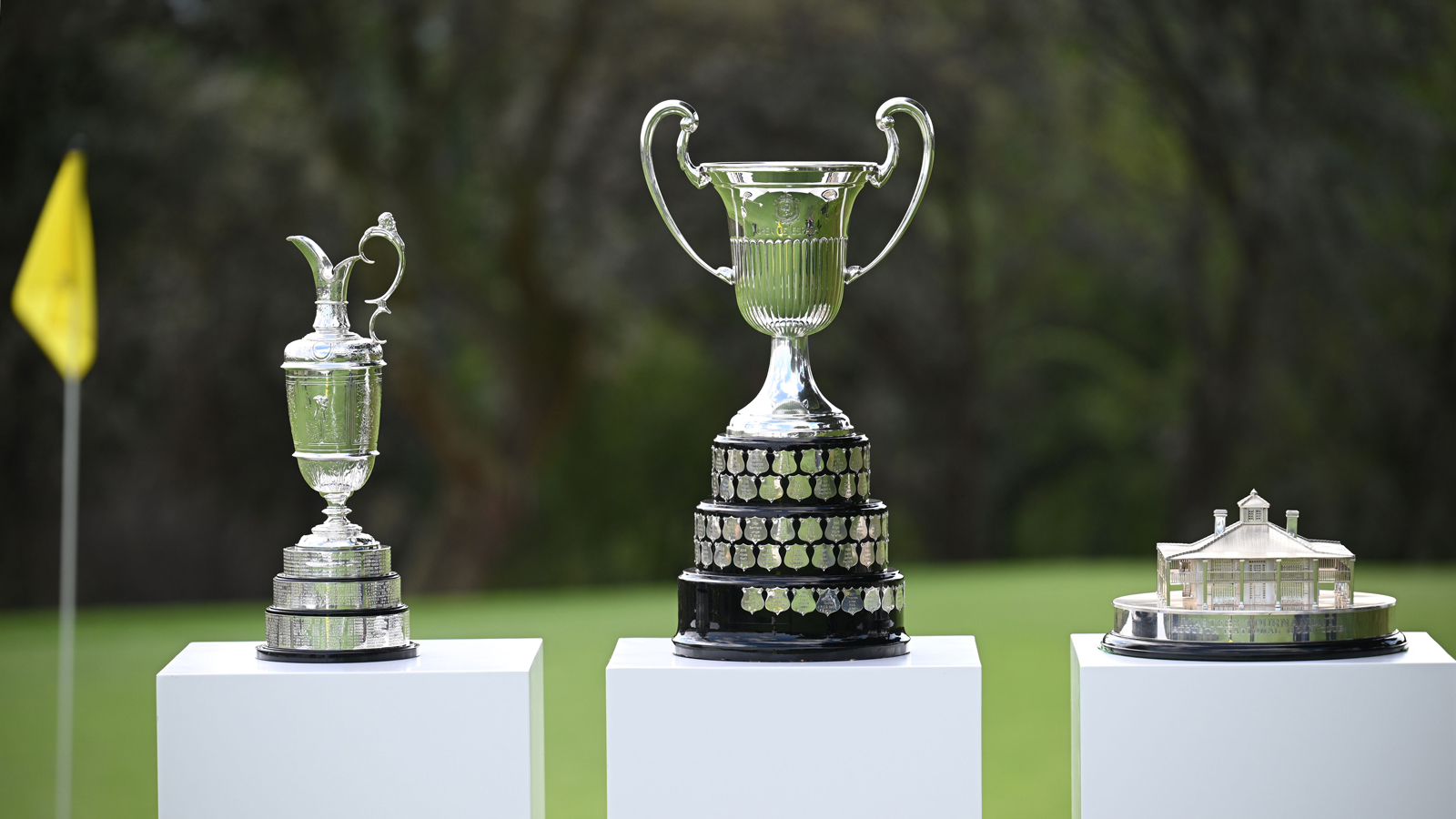 The Claret Jug, Open de Espana and Masters trophy on plinths