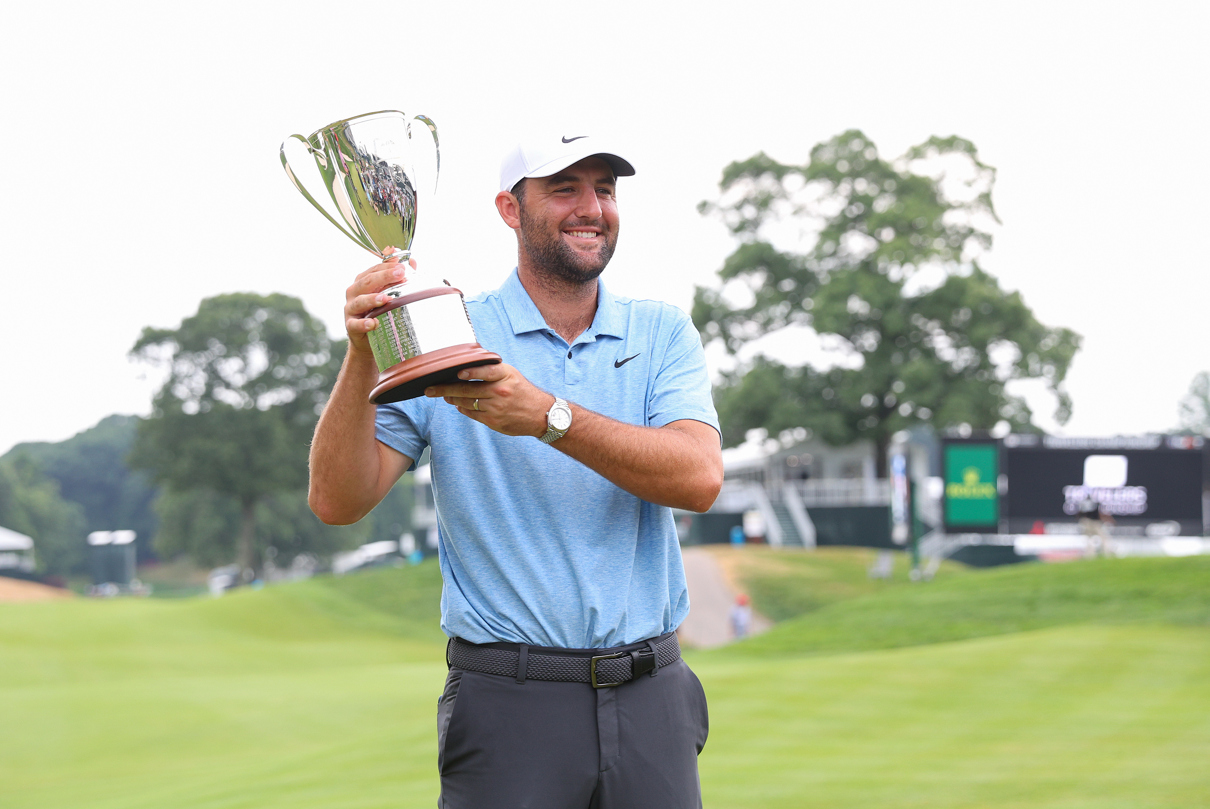 Scottie Scheffler holds the Travelers Championship trophy