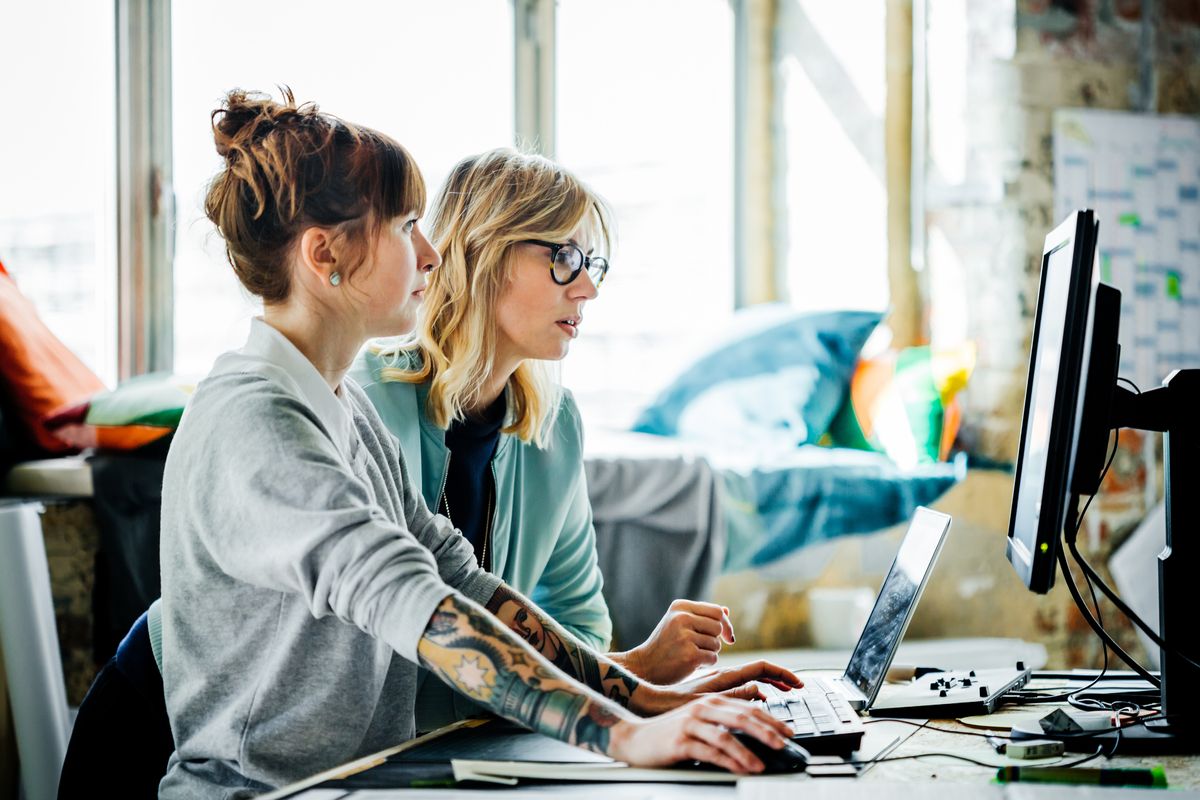 Two businesswomen working on a computer