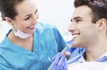 Female dentist with male patient