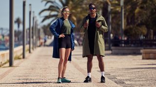 Two models wear Red Equipment Pursuit changing robe on an esplanade