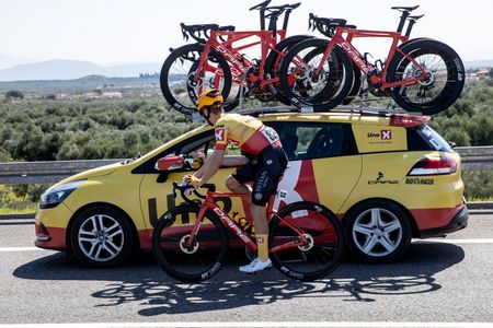 Uno-X rider at team car in a race