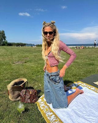 @emilisindlev wearing denim Bermuda shorts and cardigan