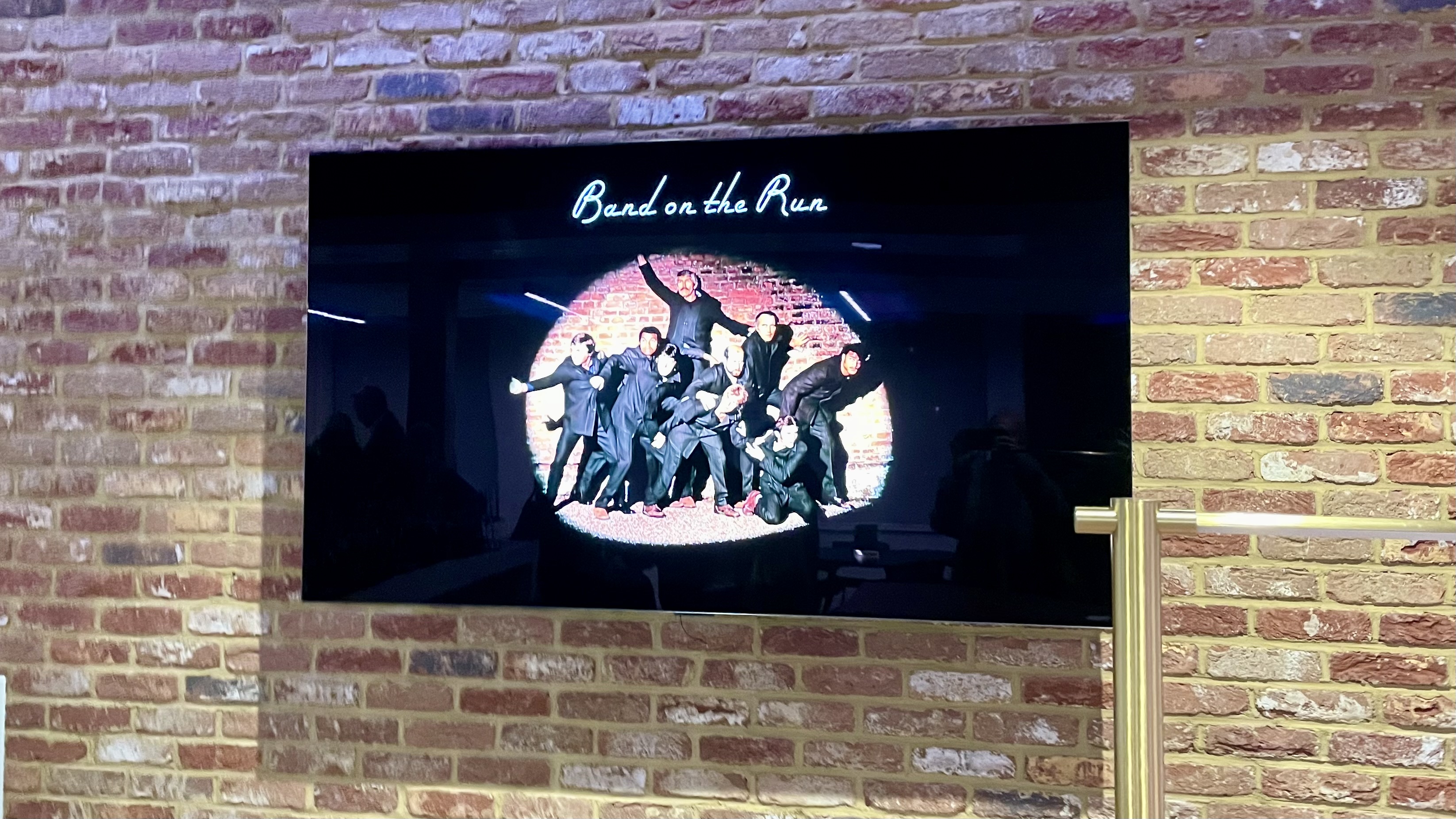 Band on the Run artwork, on a TV at Dolby Soho Square
