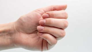 Close-up on person's hand with short nails