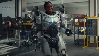 Riri Williams smiling as she wears her white and silver super-suit in Marvel's Ironheart TV show