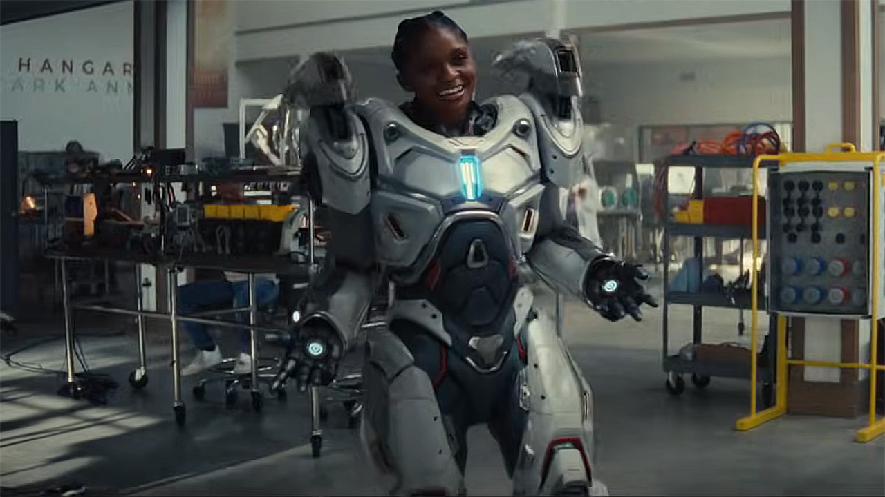 Riri Williams smiling as she wears her white and silver super-suit in Marvel&#039;s Ironheart TV show