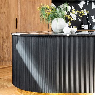 Black reeded kitchen island with curved finish