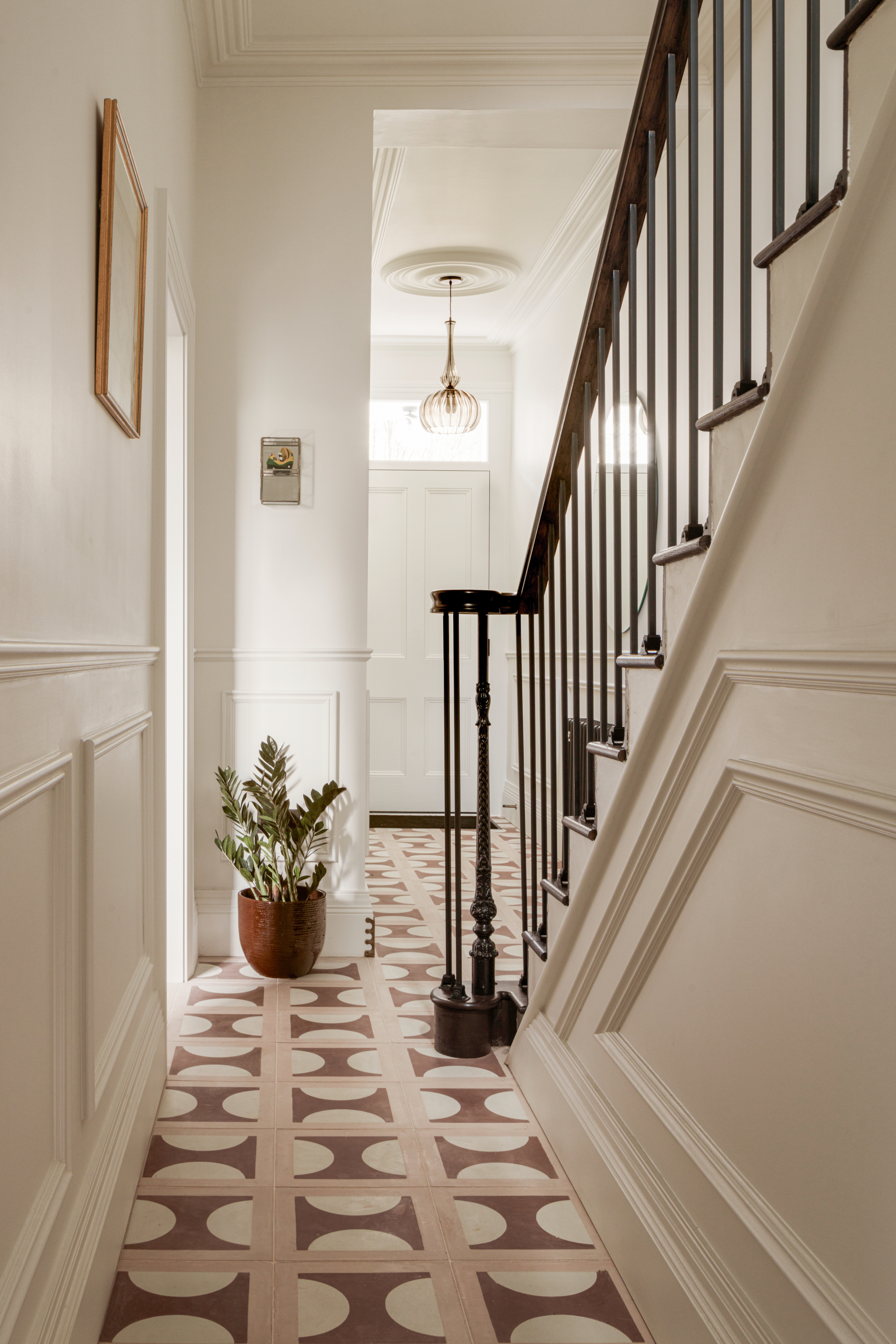 Cream fireplace with pink and brown encaustic floor tiles