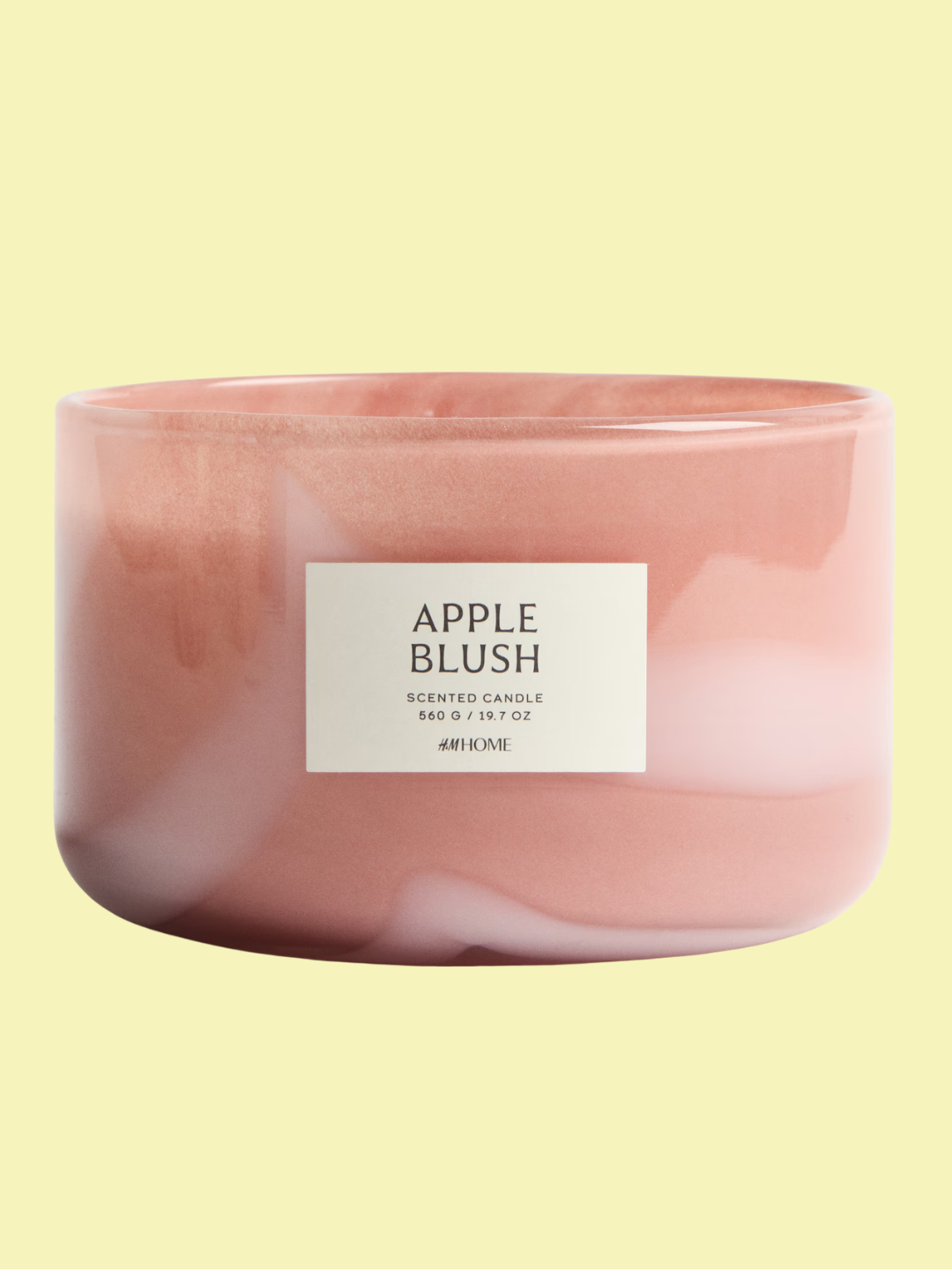 An apple blush candle in a pink glass vessel from H&amp;amp;M