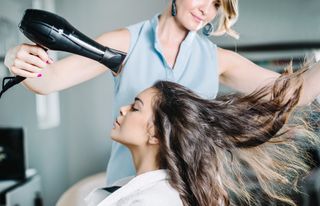 Woman having her hair blow-dried