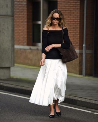 @anoukyve wearing an off the shoulder top and skirt