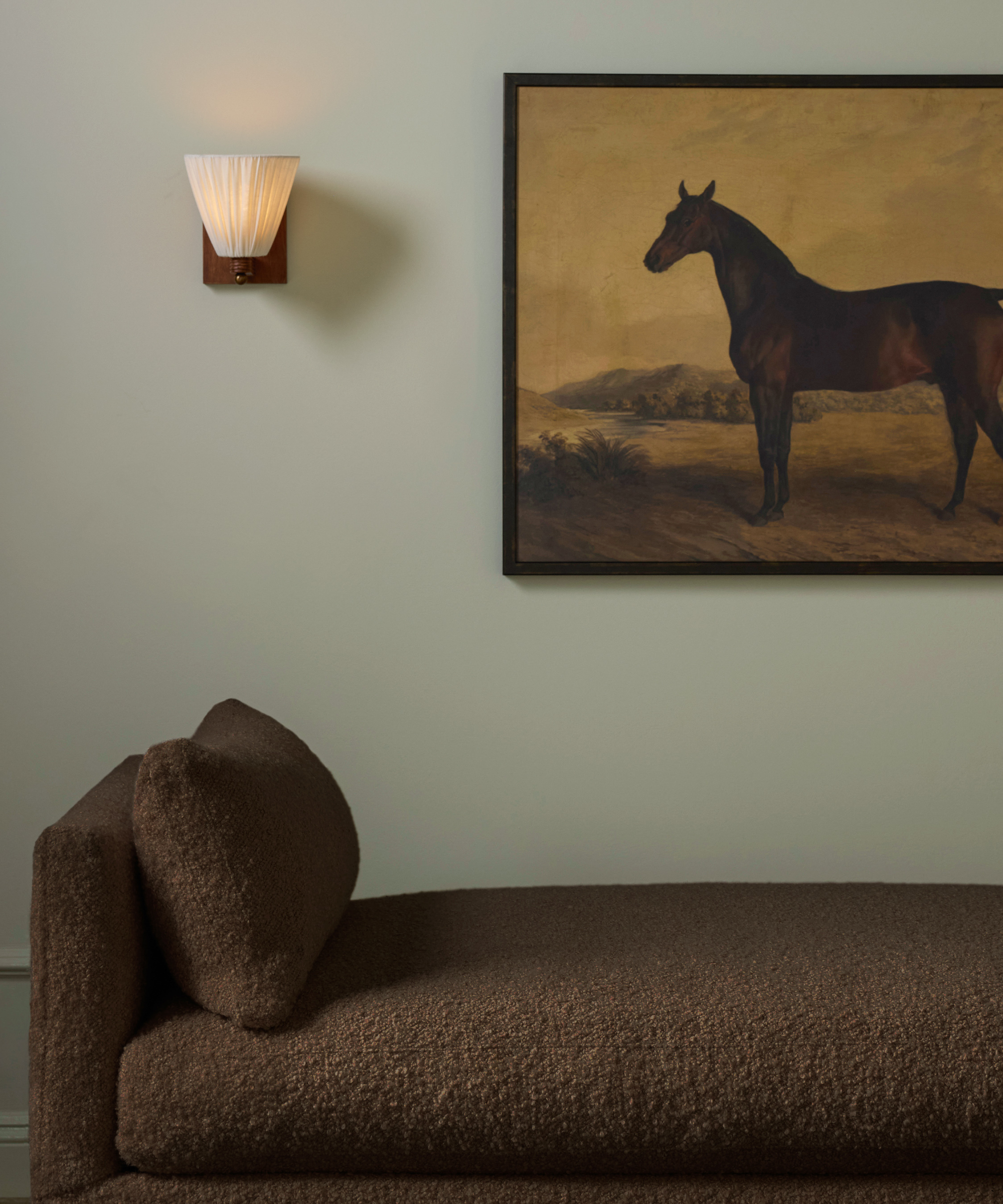 Huey lighting for Lulu and Georgia in a room with a brown divan and a painting of a horse