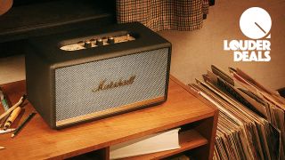 A Marshall Stanmore II Bluetooth speaker on a desk with vinyl records